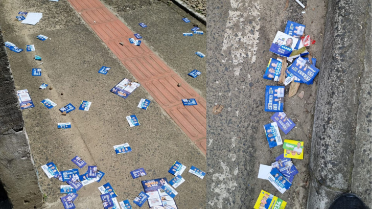 Santinhos espalhados em frente à EEB Irmã Edviges, no bairro Mina União.